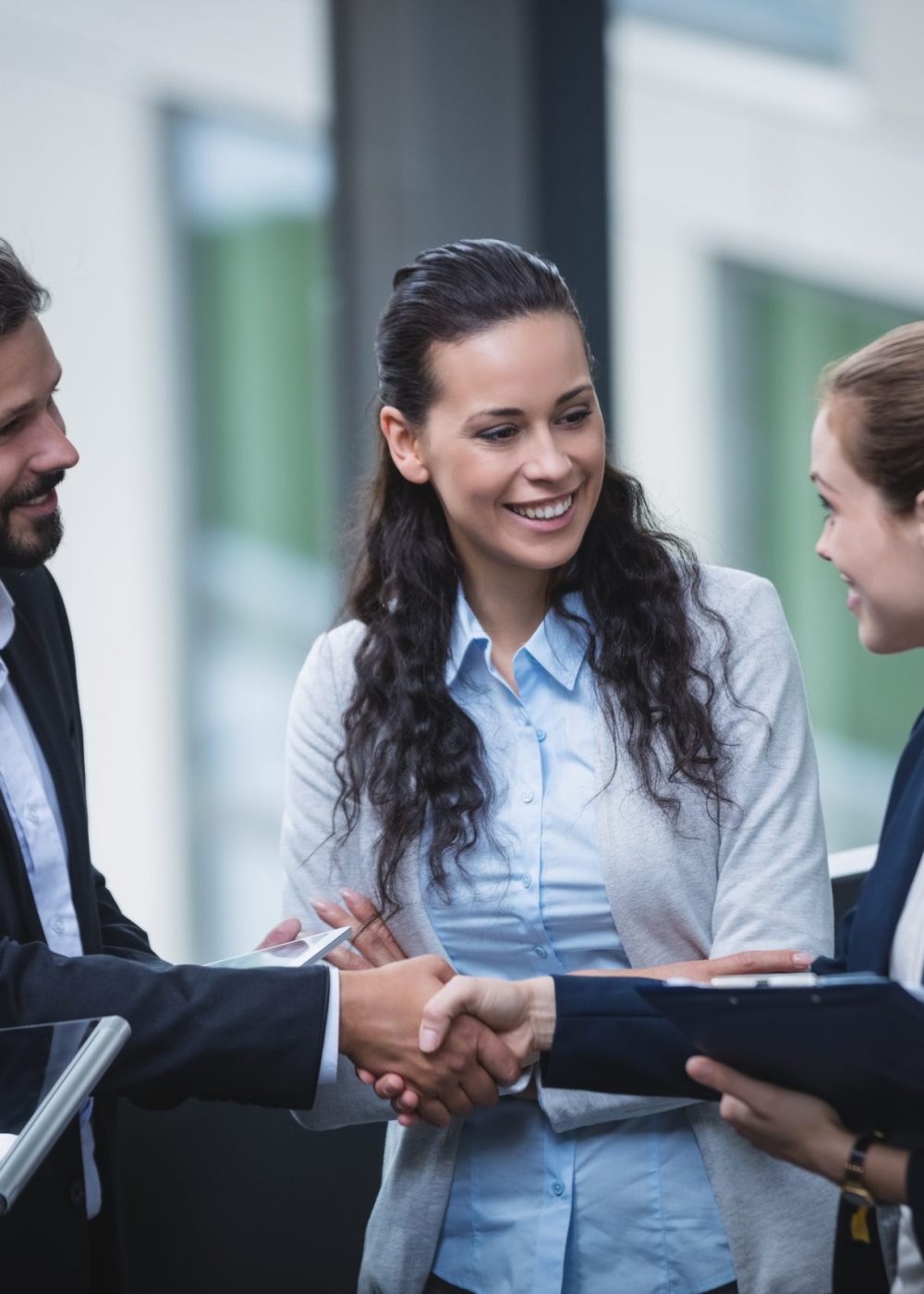 Group of businesspeople having a discussion near staircase in office